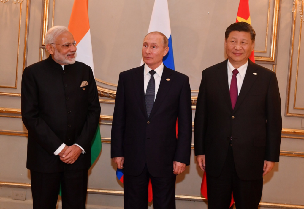 A photo of Modi, Putin, and Xi standing from left to right at the G20 summit in Argentina