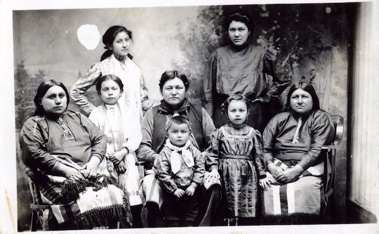 Eight women and girls, young and old, pose for a group photograph.
