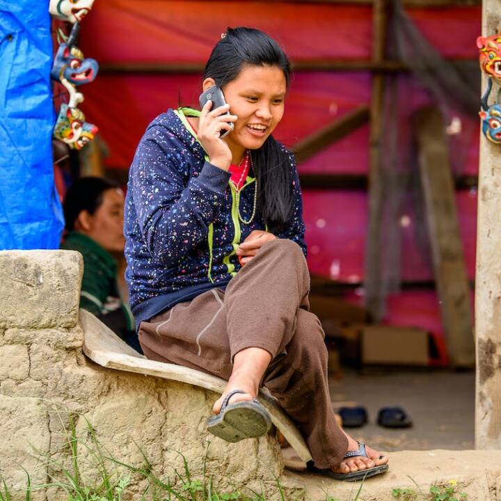 A Bhutanese woman on a phone.